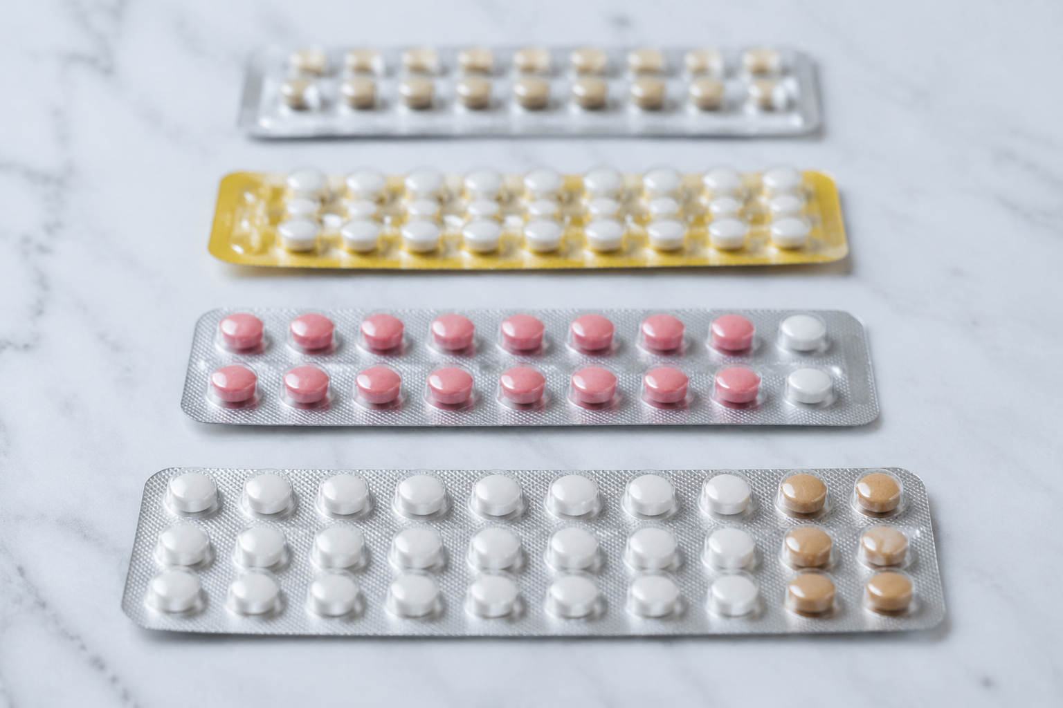 Different oral contraceptive pill packs compared side by side for acne treatment use with spironolactone